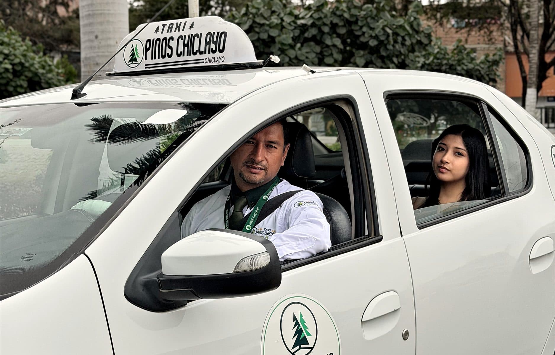 Taxi Pinos Plus con conductor uniformado y pasajera